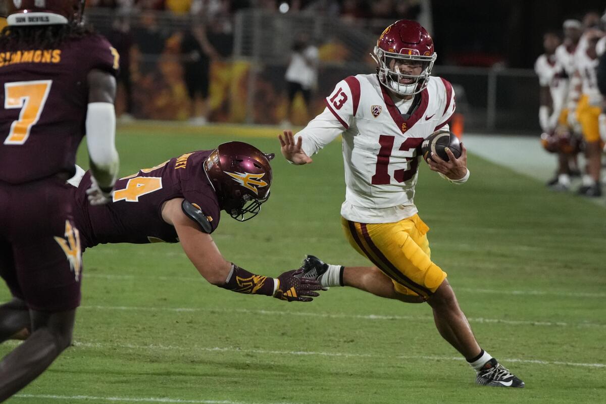 USC quarterback Caleb Williams carries the ball against Arizona State in the first half.