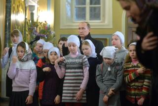 FILE - Russian President Vladimir Putin attends a midnight Mass on Russian Orthodox Christmas in the village of Turginovo, about 150 kilometers (90 miles) northwest of Turginovo, Russia on Jan. 7, 2016. As Putin has formed a closer alliance with the Orthodox Church, the country has embraced what officials call “traditional values,” and Russia has sought to put more restrictions on abortion. Russia’s health minister has condemned women for prioritizing careers over childbearing. (Alexei Druzhinin, Sputnik, Kremlin Pool Photo via AP, File)