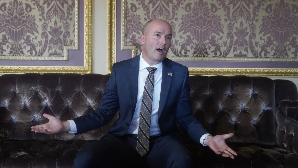 Utah Gov. Spencer Cox speaks during an interview at the Utah State Capitol, Friday, March 4, 2022, in Salt Lake City. Transgender girls in Utah won't be able to play sports on teams that correspond with their gender identity under legislation that the state Senate passed late Friday. Eleventh-hour amendments introduced in the final hours before lawmakers adjourn must return to the House for approval and then be signed by Republican Gov. Spencer Cox before becoming state law. (AP Photo/Rick Bowmer)