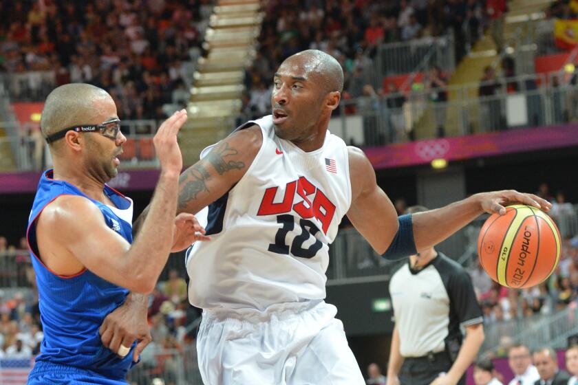 U.S. guard Kobe Bryant is challenged by French guard Tony Parker during a preliminary round game at the 2012 London Olympics.
