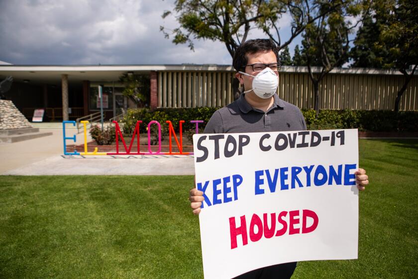EL MONTE, CA - MARCH 29: Rodolfo Cortes, 30, of El Monte and other tenant rights activists assemble at the El Monte City Hall to demand that the El Monte City Council pass an eviction moratorium barring all evictions during the coronavirus pandemic on Sunday, March 29, 2020 in El Monte, CA. (Jason Armond / Los Angeles Times)