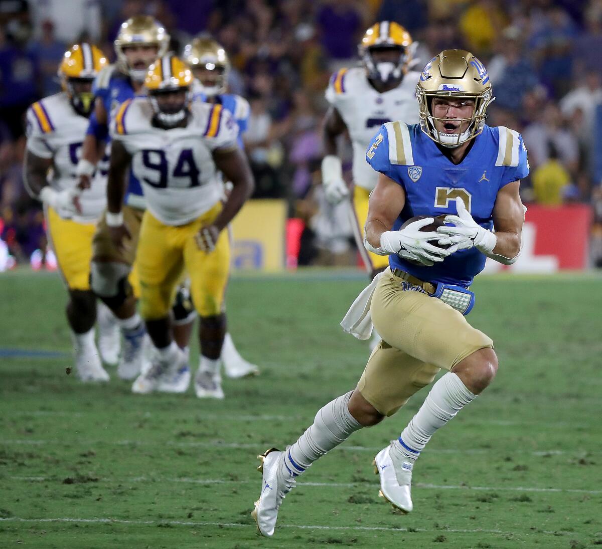 UCLA wide receiver Kyle Philips turns upfield for a touchdown run after making a catch against LSU.