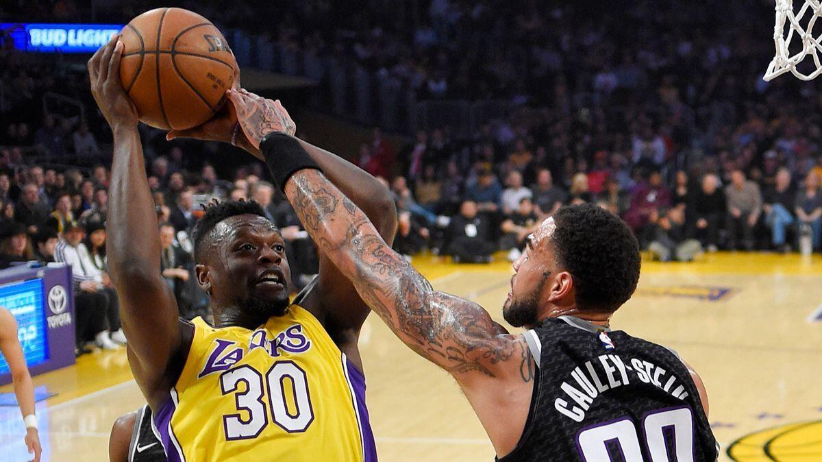 Lakers forward Julius Randle, left, shoots as Sacramento Kings center Willie Cauley-Stein defends during the first half on Tuesday.