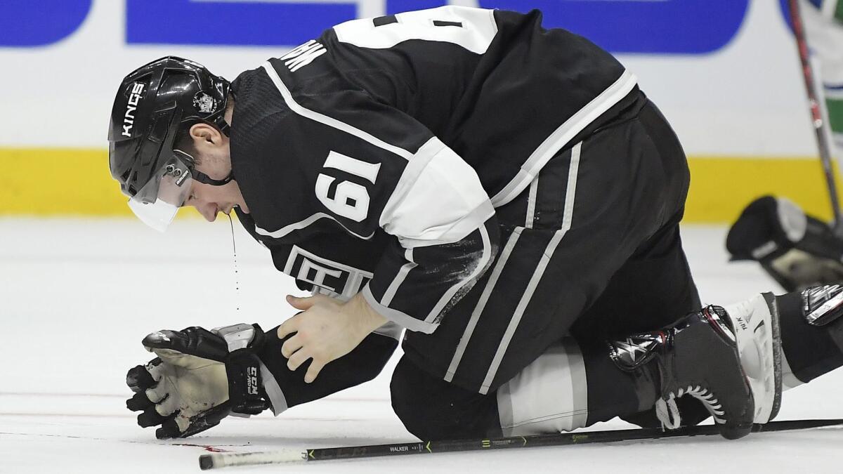 Kings defenseman Sean Walker bleeds onto the ice after taking a puck to the face against Vancouver on Feb. 14.