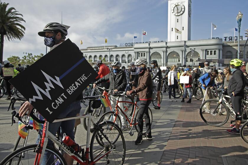 Cyclists participate in a George Floyd solidarity ride on Friday, June 5, 2020, in San Francisco. Floyd died after being restrained by Minneapolis police officers on May 25.(AP Photo/Ben Margot)