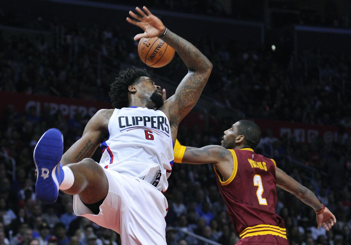 Clippers center DeAndre Jordan (6) and Cavaliers guard Kyrie Irving (2) fight for a rebound in the second quarter.
