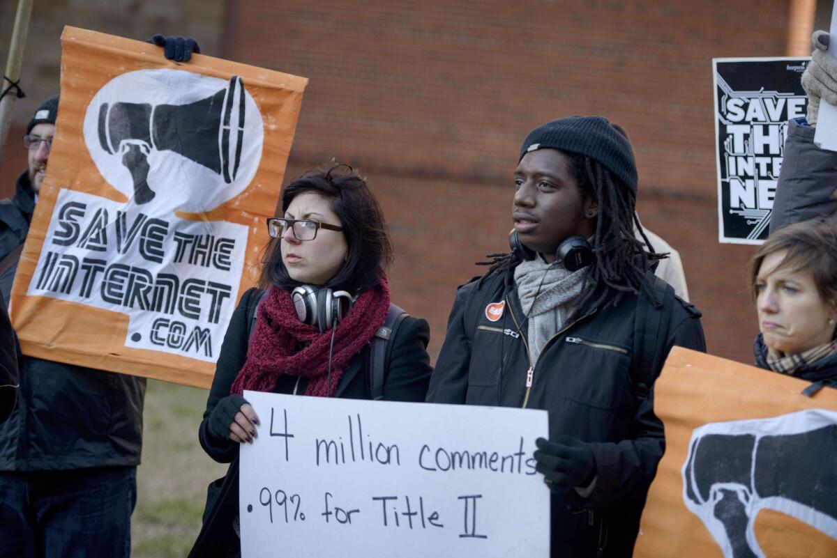 Activists gather outside the headquarters of the Federal Communications Commission in Washington on Dec. 11 to urge tough net neutrality regulations.
