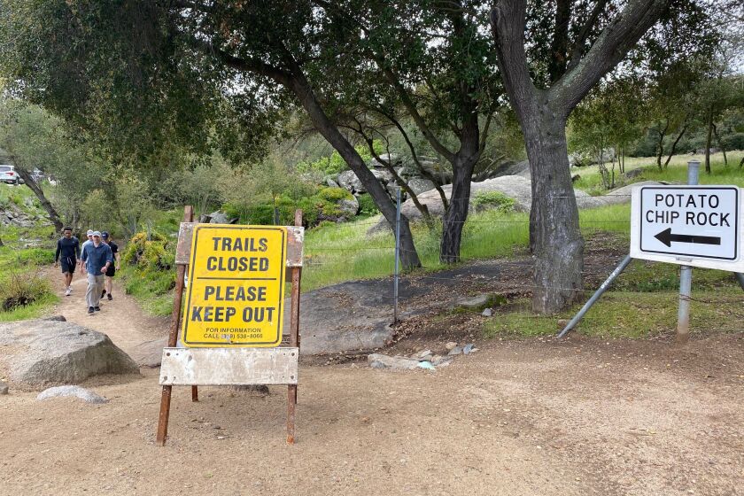 Hikers parked along SR-67 Tuesday, March 24, ignored Mt. Woodson trail closure signs, many saying they needed to get out to stop going stir crazy from shelter-in-place.