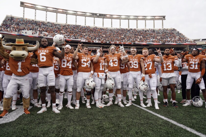 FILE - Texas players sing "The Eyes Of Texas" after defeating Kansas State 22-17 in an NCAA college football game in Austin, Texas, Friday, Nov. 26, 2021. Six months after one of the biggest rule changes in the history of college sports, money for athletes is being pledged by the millions in a development that has raised concerns about the role of wealthy alumni eager to back their beloved alma maters. At Texas, one group is dangling $50,000 a year for individual offensive linemen while another says it already has $10 million promised for Longhorns athletes. (AP Photo/Chuck Burton, File)