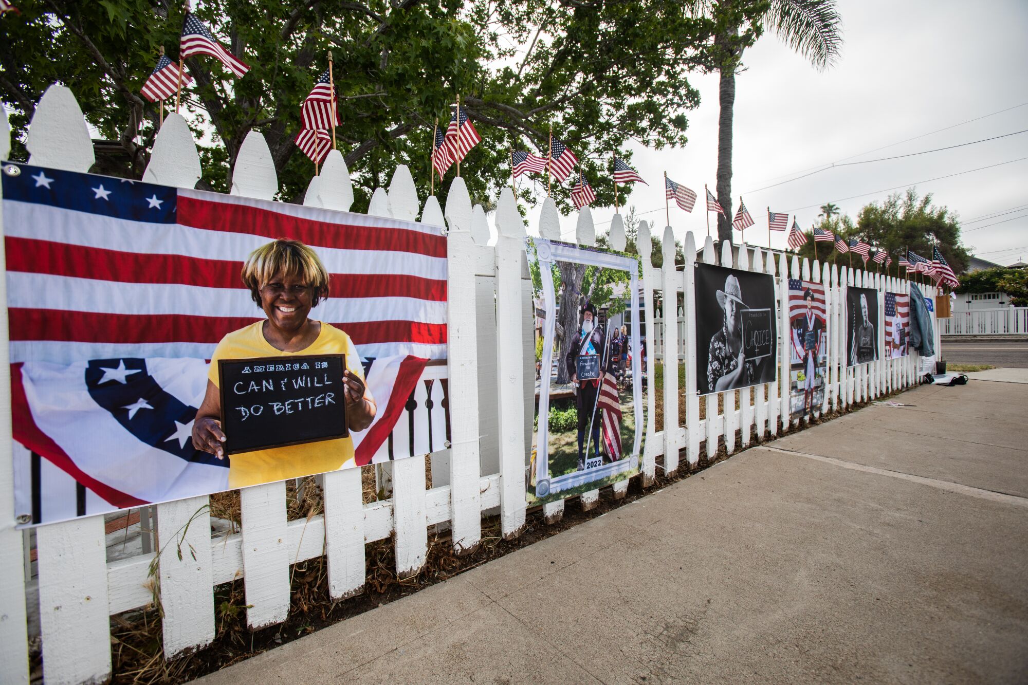 Portraits taken by Todd Bradley are displayed along a fence in Normal Heights San Diego, CA on Saturday, July 1, 2023.