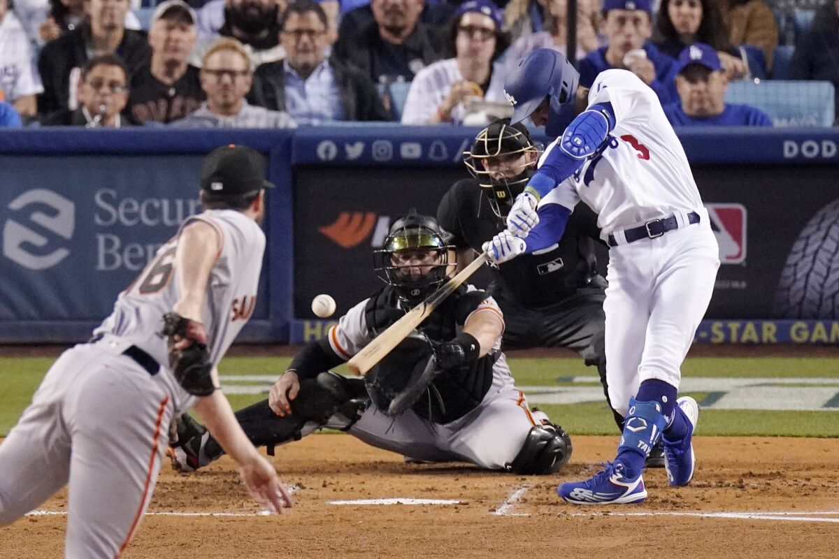 The Dodgers' Chris Taylor hits a two-run single off San Francisco Giants pitcher Carlos Rodón on May 3, 2022.