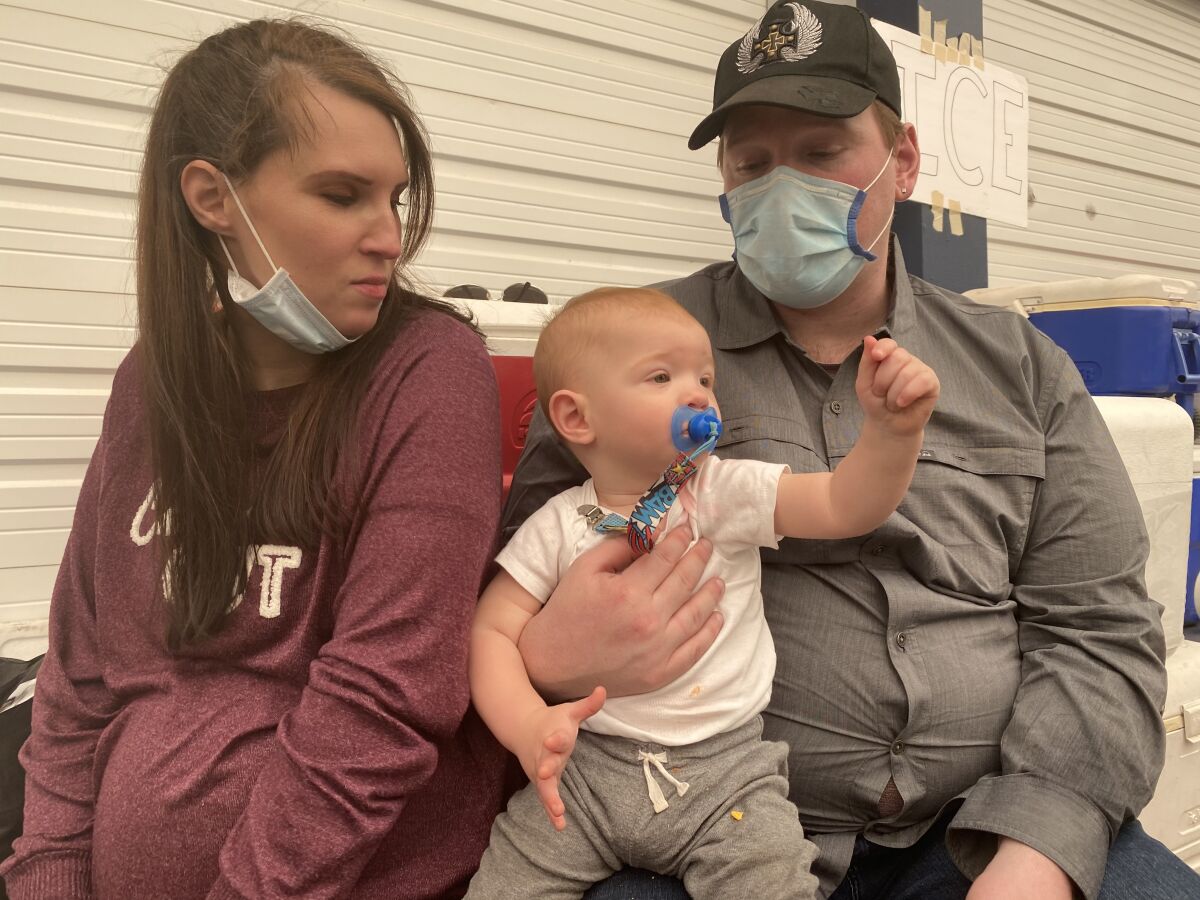 Elisha Goodrick, who is more than eight months pregnant, and James Rethaford, fled a wildfire with Korbin, their toddler.