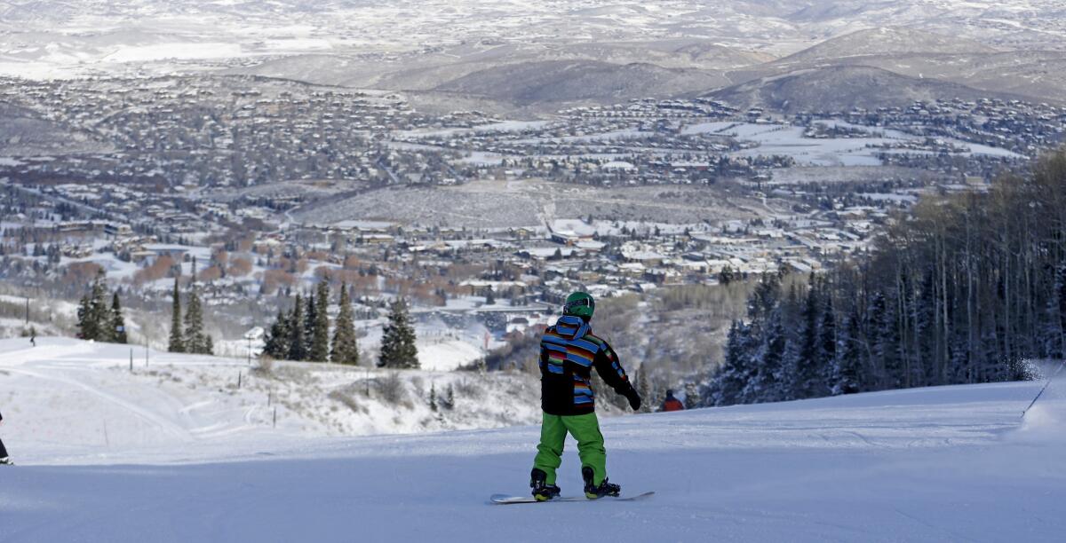 A snowboarder at Park City Mountain Resort boards down a slope in Park City, Utah.