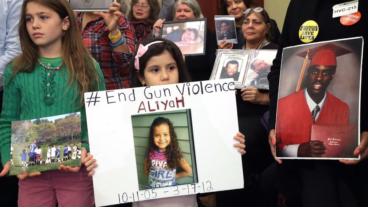 Family members and friends of people killed by gun violence gather for a news conference with Congressional Democrats to call for action on gun violence prevention at the U.S. Capitol in December 2016.