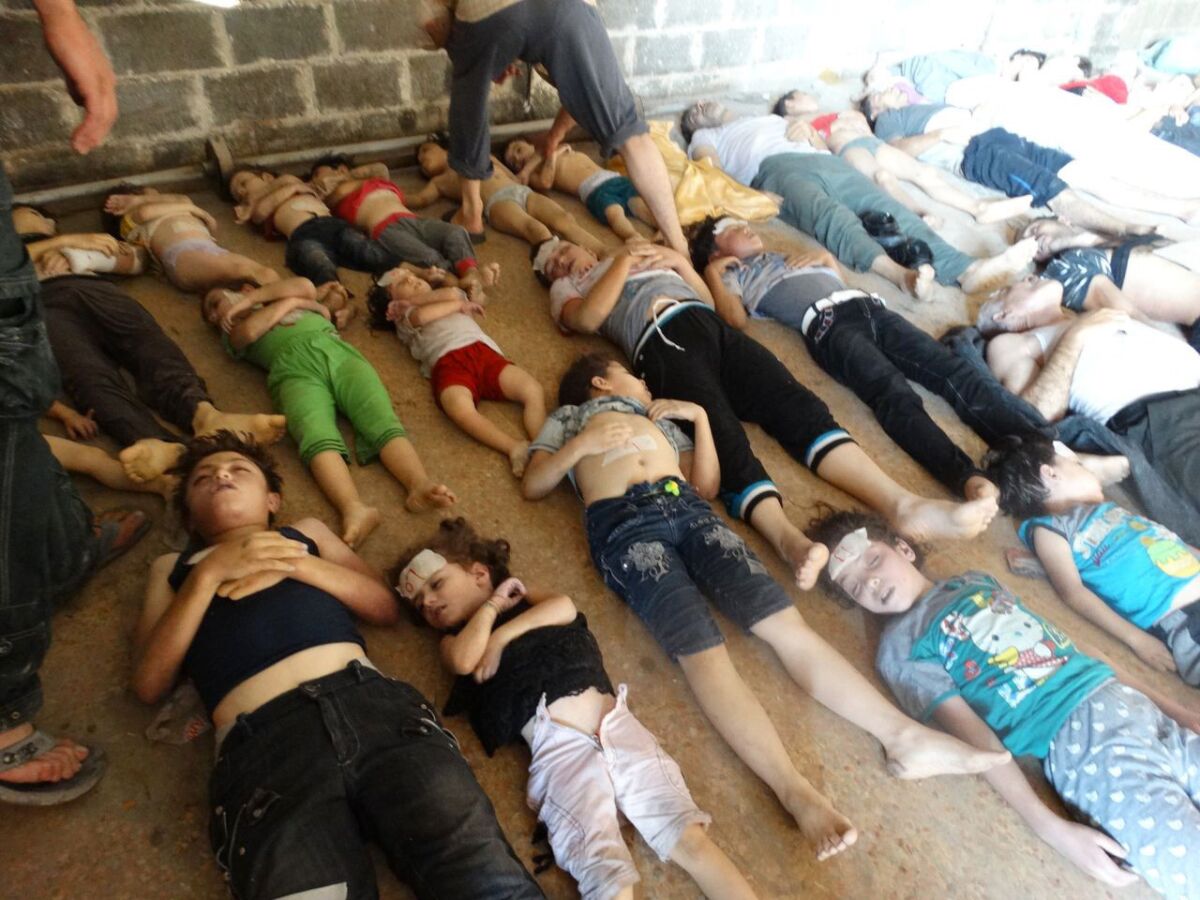 This image provided by Shaam News Network on Aug. 22, which has been authenticated based on its contents and other Associated Press reporting, purports to show bodies of victims of an attack on Ghouta, Syria, on Aug. 21.