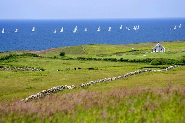 Looking across the Lewis Farm at sailboats on the Atlantic. Block Island is 13 miles off the Rhode Island coast and 14 miles from the eastern tip of Long Island. The island is less than 11 square miles and can be explored on foot or rented bicycle.