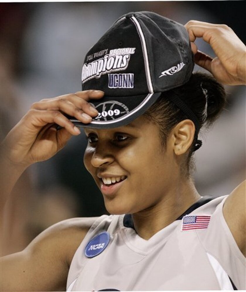 Connecticut's Maya Moore puts on a champion's hat after Connecticut defeated Arizona State 83-64 in a women's NCAA college basketball tournament regional final Tuesday, March 31, 2009, in Trenton, N.J. (AP Photo/Mel Evans)