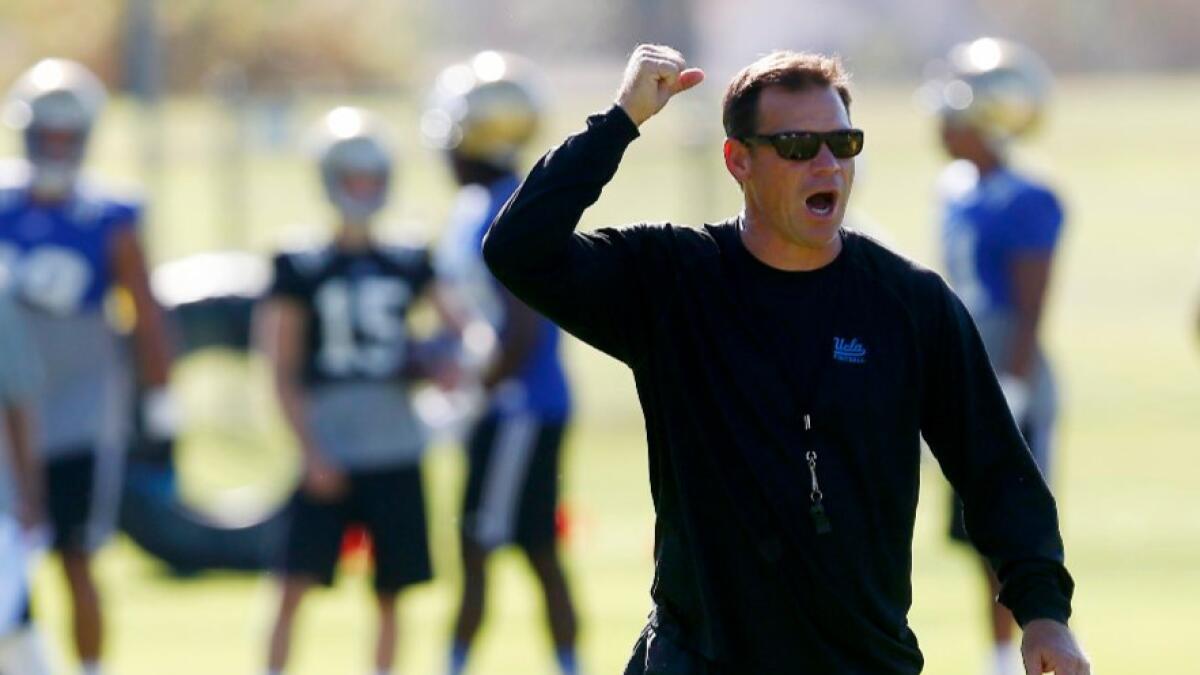 UCLA Coach Jim Mora directs practice during training camp at Cal. State San Bernardino on Aug. 15.