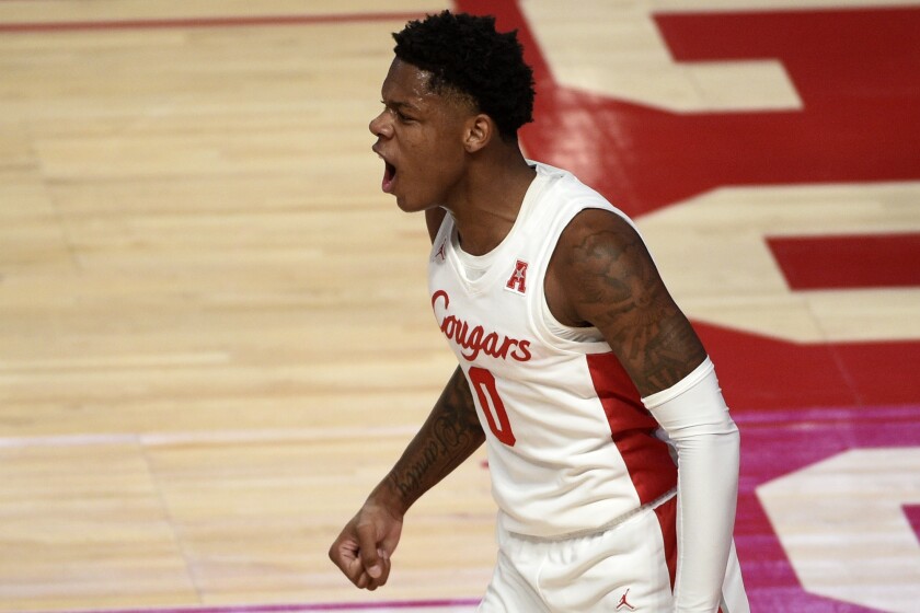 Houston guard Marcus Sasser (0) reacts after drawing a foul during the first half of an NCAA college basketball game against Tulane, Saturday, Jan. 9, 2021, in Houston. (AP Photo/Eric Christian Smith)