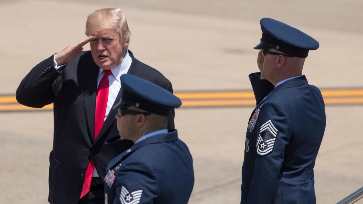 President Trump salutes as he boards Air Force One at Naval Air Station Norfolk, in Virginia, on July 22.