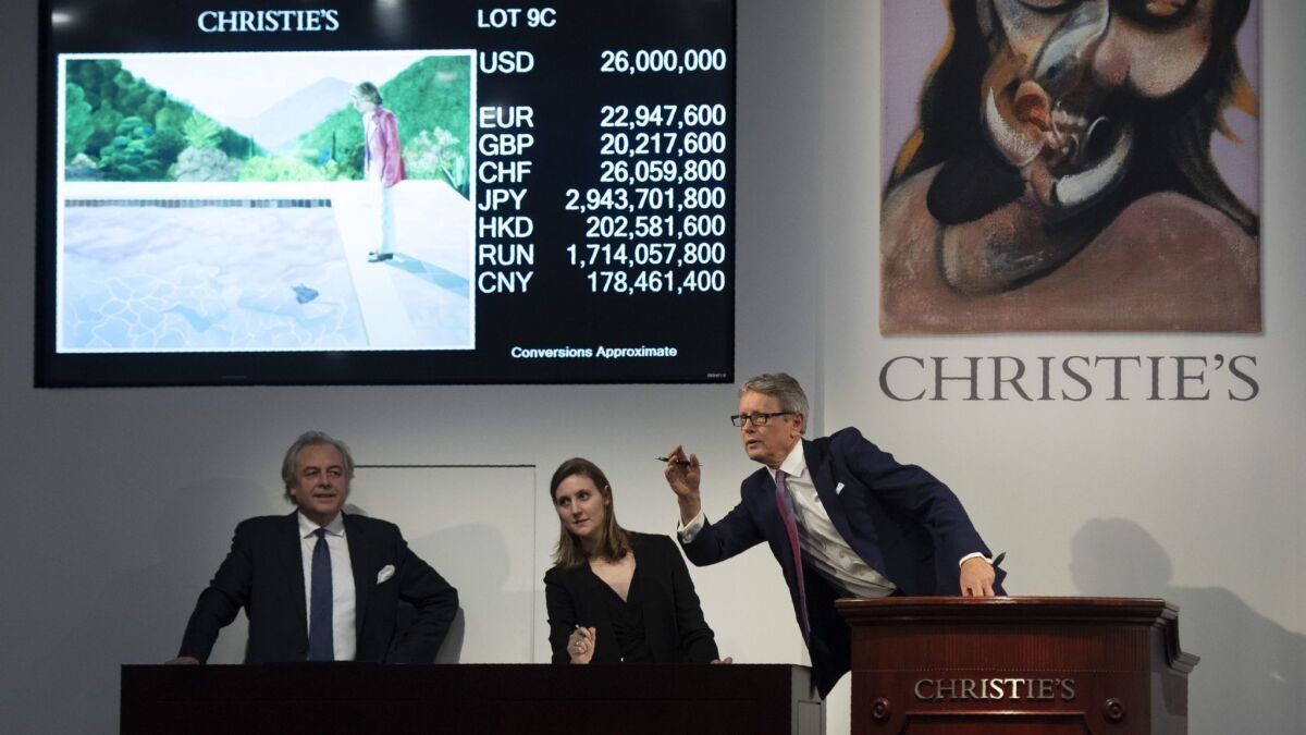 The auctioneer takes bids for the sale of David Hockney's Portrait of an Artist (Pool with Two Figures) during the Post-War and Contemporary Art Evening Sale November 15, 2018 at Christie's in New York. - David Hockneys Famed Pool Scene Sells for $90.3 M. at Christies.