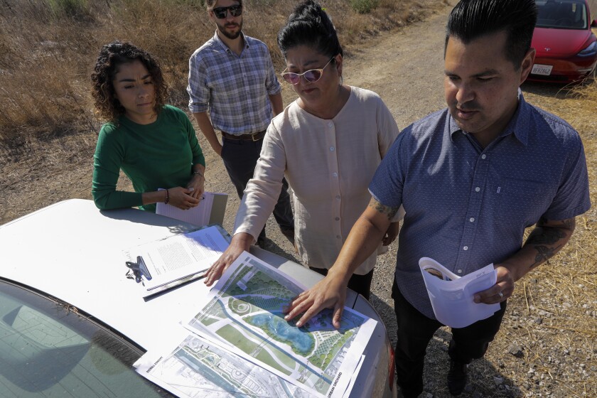 Lucy Barraza, left, Sam Ward, Wendy Katagi, from Stillwater Sciences, and landscape designer Matt Romero from Studio-MLA, discuss the planned Urban Orchard Park.