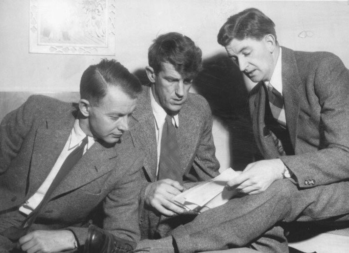 Dr. Charles Evans (left), Sir Edmund Hillary and George Lowe, members of the expedition that conquered Mt. Everest, look over plans to climb 24,000-foot Chim Ling.
