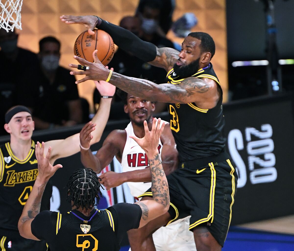 Lakers forward LeBron James steals the ball from Miami's Jimmy Butler during the fourth quarter of Game 2.
