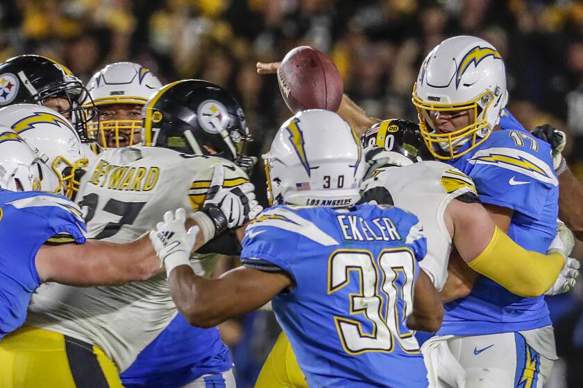 CARSON, CA, SUNDAY, OCTOBER 13. 2019 - Los Angeles Chargers quarterback Philip Rivers (17) is hit by Pittsburgh Steelers outside linebacker T.J. Watt (90) as he releases a pass to Los Angeles Chargers running back Austin Ekeler (30) to keep a fourth quarter scoring drive alive at Dignity Health Sports Park (Robert Gauthier/Los Angeles Times)