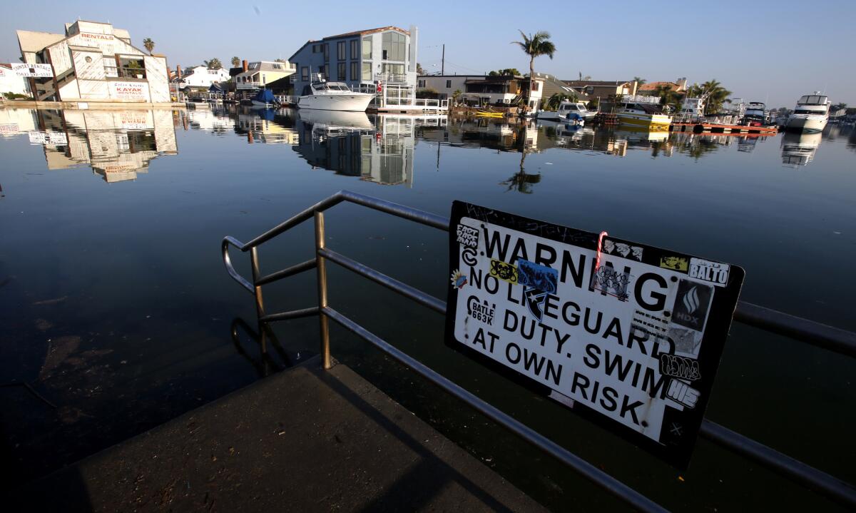 High water levels flood the stairwell leading to a small beach primarily used by kayakers in Sunset Beach during a king tide in December 2014.