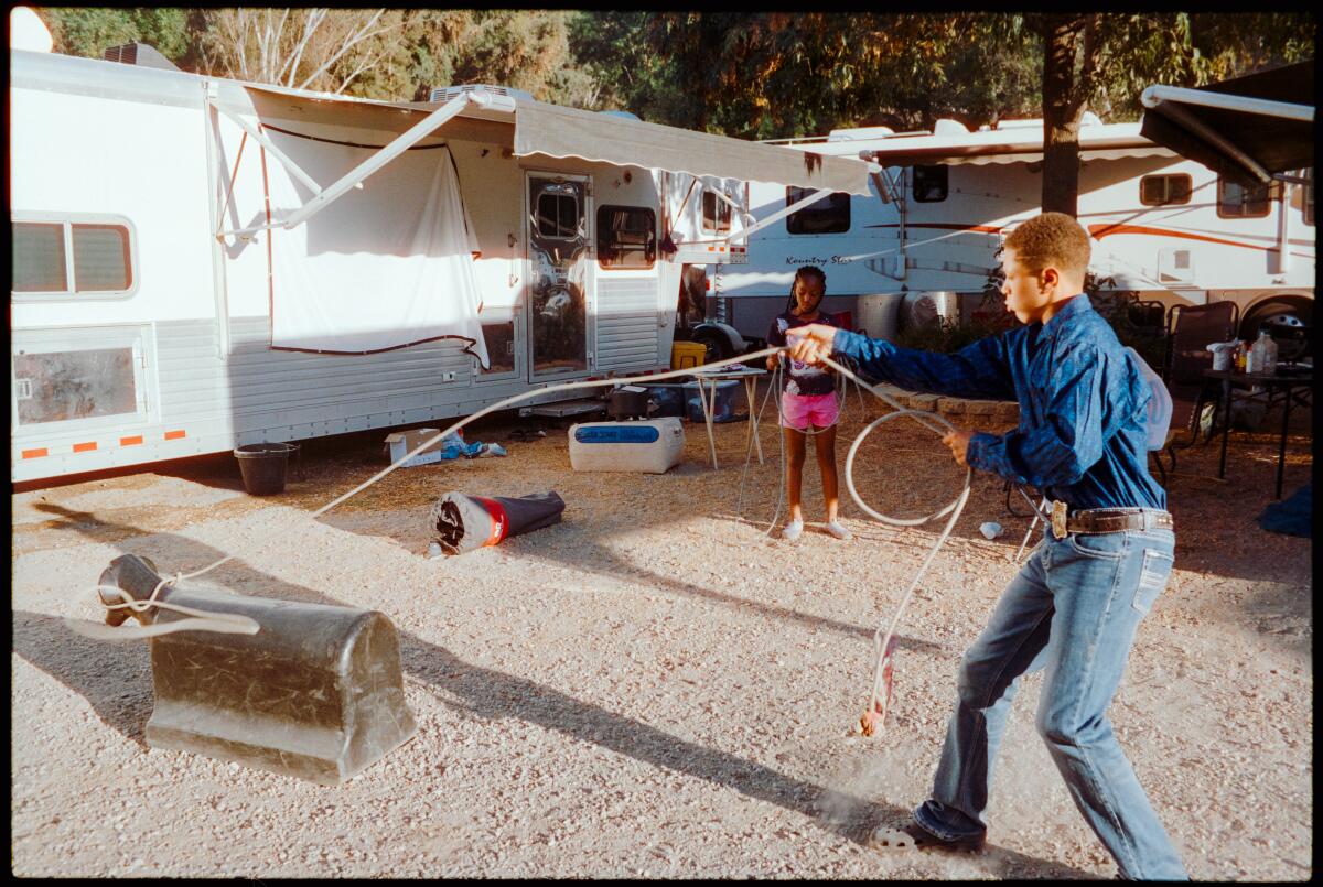 A young man practicing his lassoing skills at Bill Pickett Rodeo.