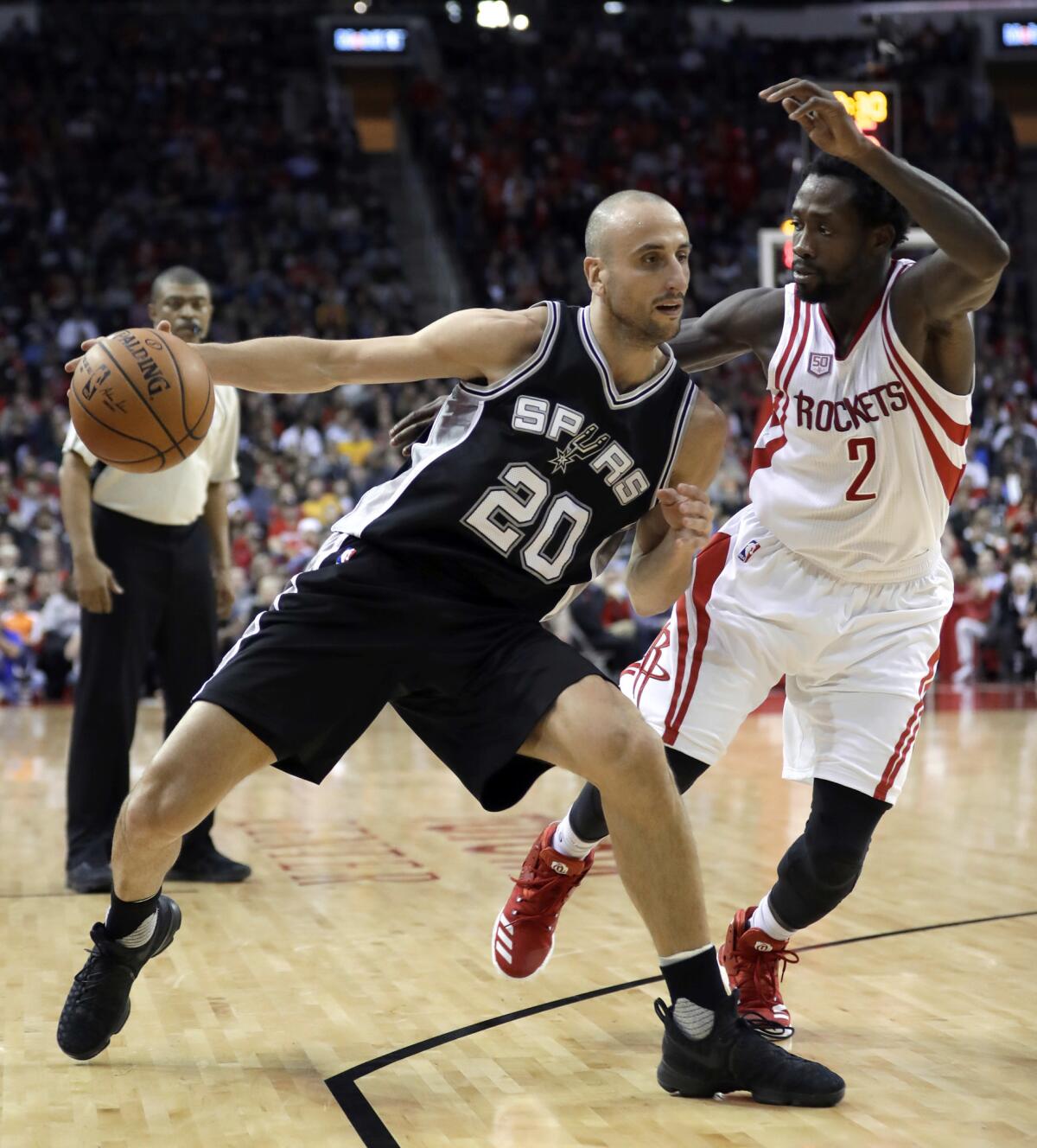 San Antonio Spurs' Manu Ginobili (20) drives toward the basket as Houston Rockets' Patrick Beverley (2) defends during the second half of an NBA basketball game Tuesday, Dec. 20, 2016, in Houston. The Spurs won 102-100.