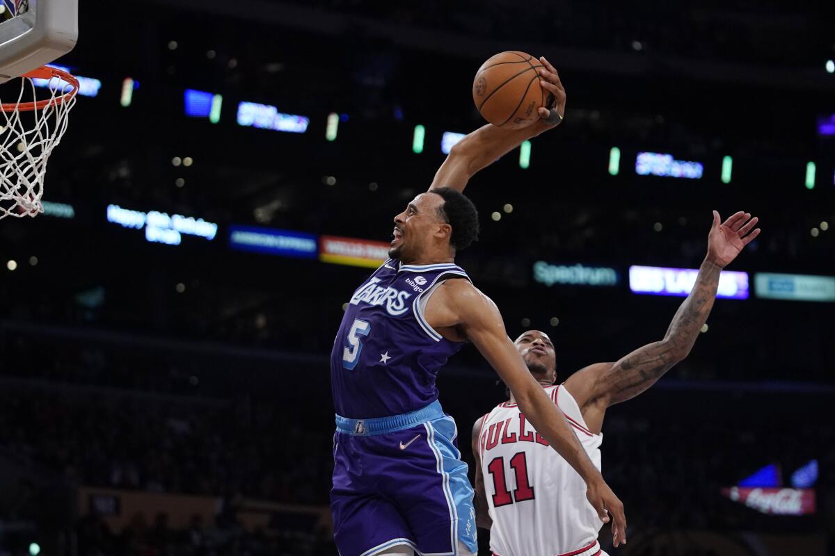 Lakers guard Talen Horton-Tucker dunks in front of Chicago Bulls forward DeMar DeRozan.