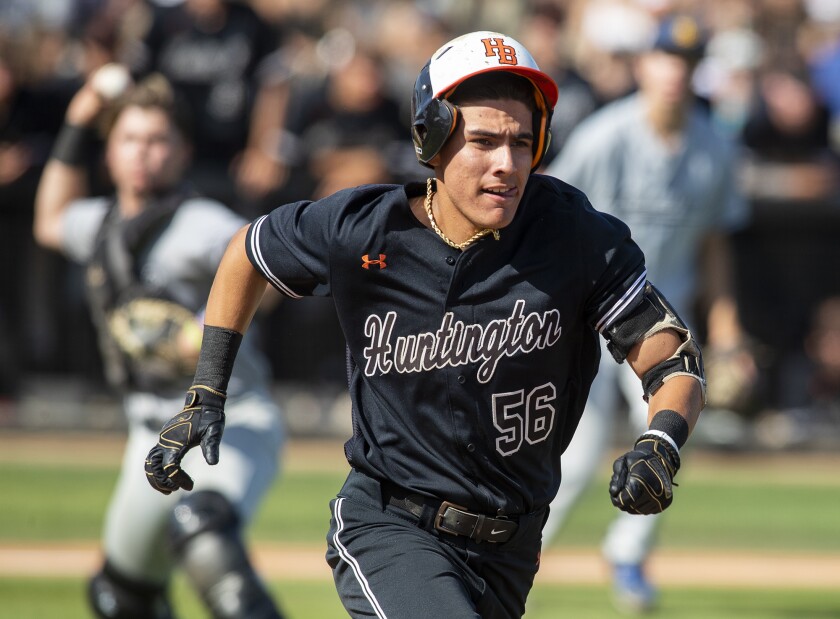 Huntington Beach's Brian Trujillo tries to run out a bunt during the Division 1 semifinal game Tuesday.