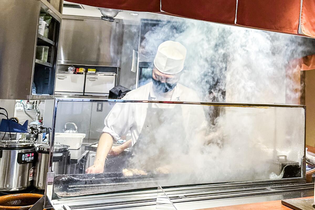 A chef works the grill at Kyobashi Isehiro in Tokyo.