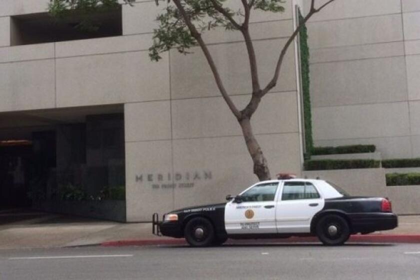 A San Diego Police Department patrol car is parked outside the Meridian condos on Saturday, June 30, 2018, after a woman died at the complex.