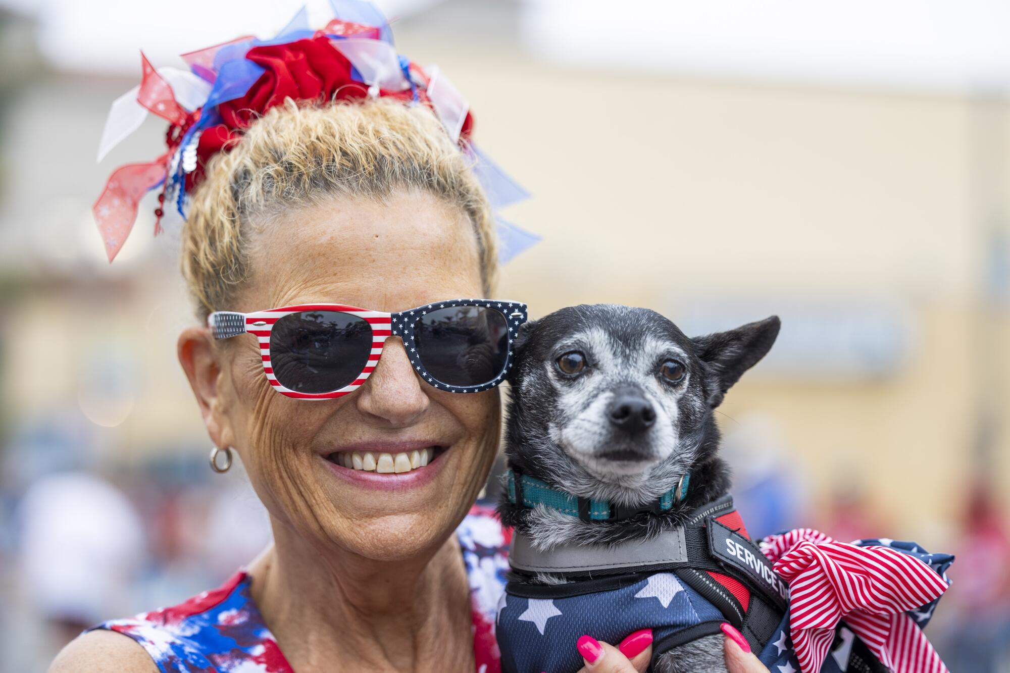 Donna Morici, with her dog, at the annual Huntington Beach Independence Day Parade.