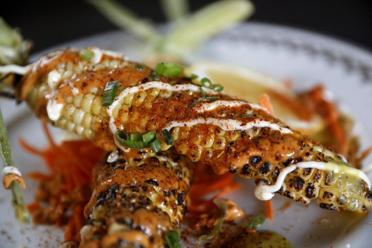 Street corn, roasted corn, sour cream, lime and house chile powder at Tacos & Mezcal in Bell.