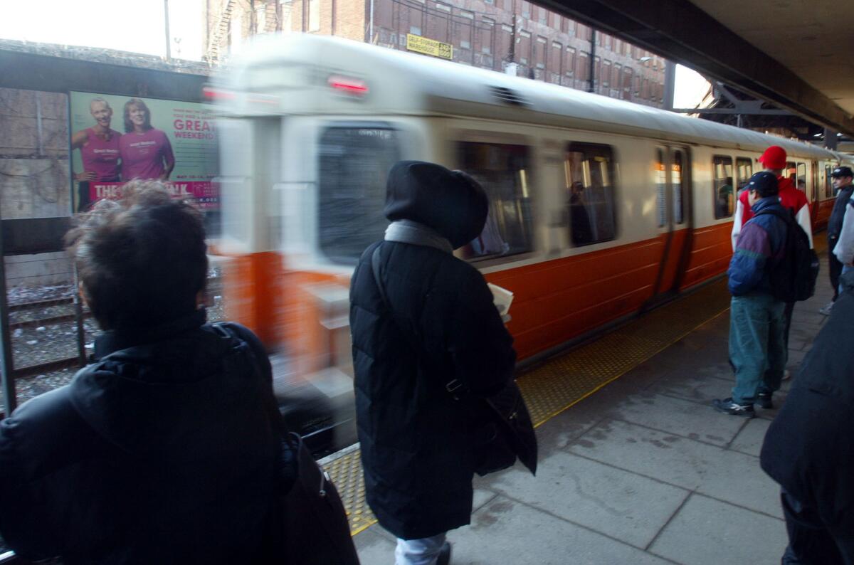 Commuters wait for trains at the Sullivan Square Station on the Orange Line of Boston's subway system in the Charlestown neighborhood of Boston, Friday, March 12, 2004. Following the terrorist attack on a commuter train in Spain, transit riders said a bit more security would be welcomed. (AP Photo/Robert Spencer)