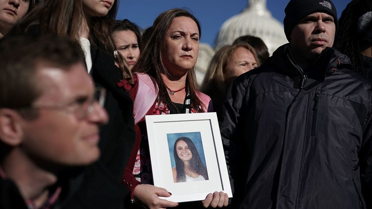 Lori Alhadeff holds a picture of her daughter, Alyssa, during a news conference on gun control on March 23 in Washington.