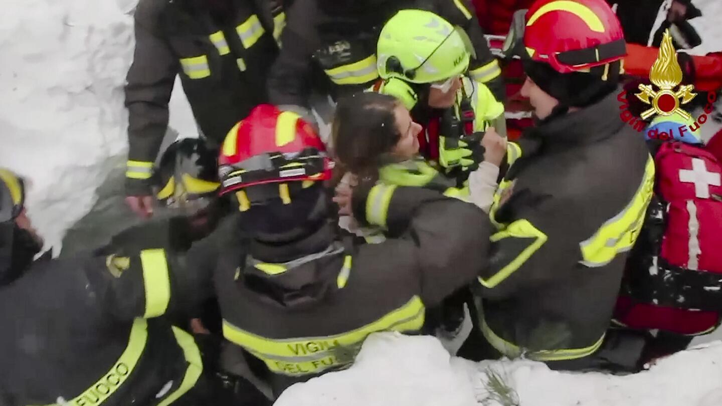 This frame from video shows Italian firefighters extracting a woman alive from under snow and debris of an hotel that was hit by an avalanche on Wednesday, in Rigopiano, central Italy on Jan. 20, 2017.