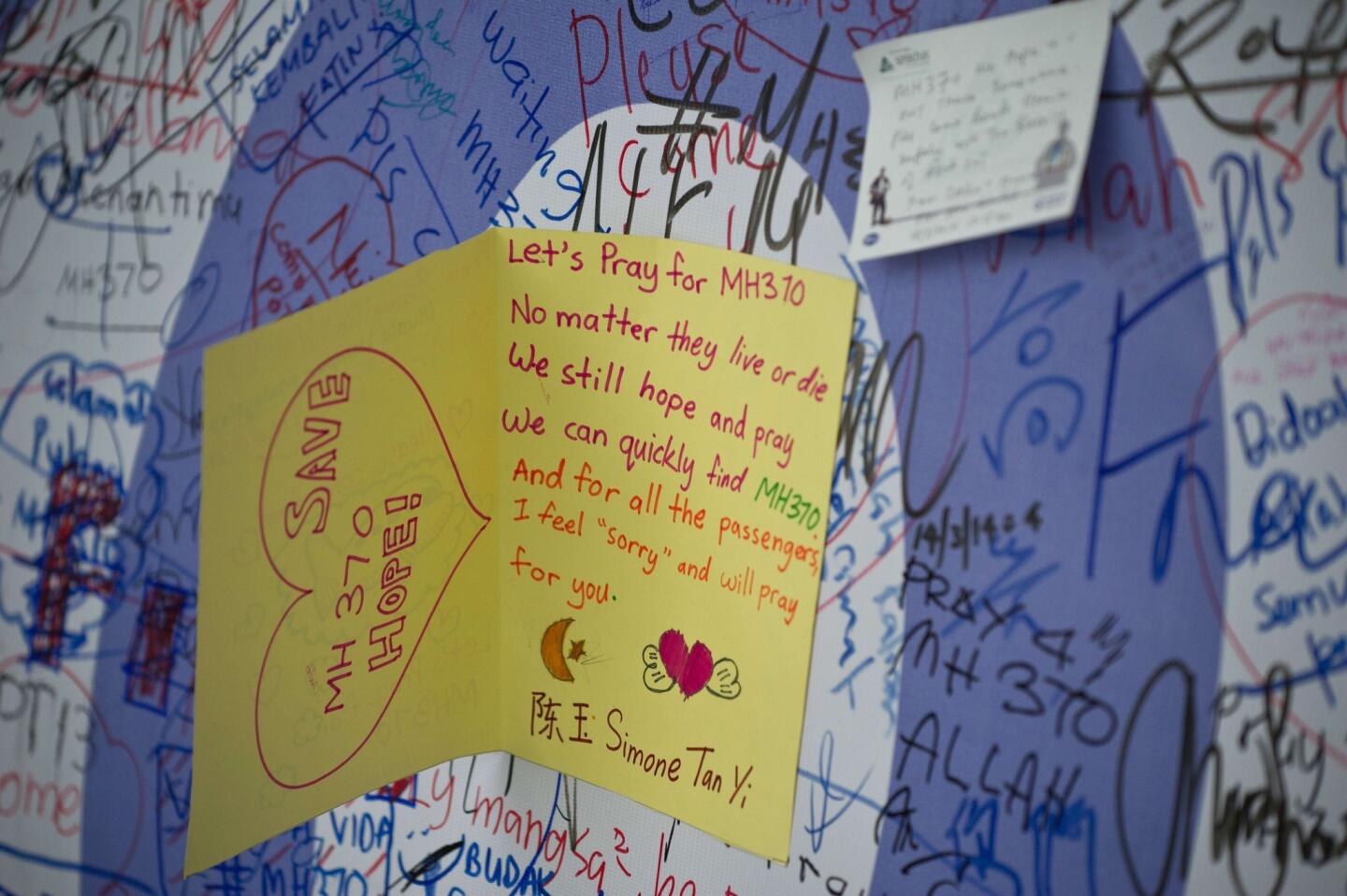 Messages for the passengers of missing Malaysia Airlines flight MH370 are posted on a wall display at Kuala Lumpur International Airport (KLIA) in Sepang, outside Kuala Lumpur on March 18, 2014.