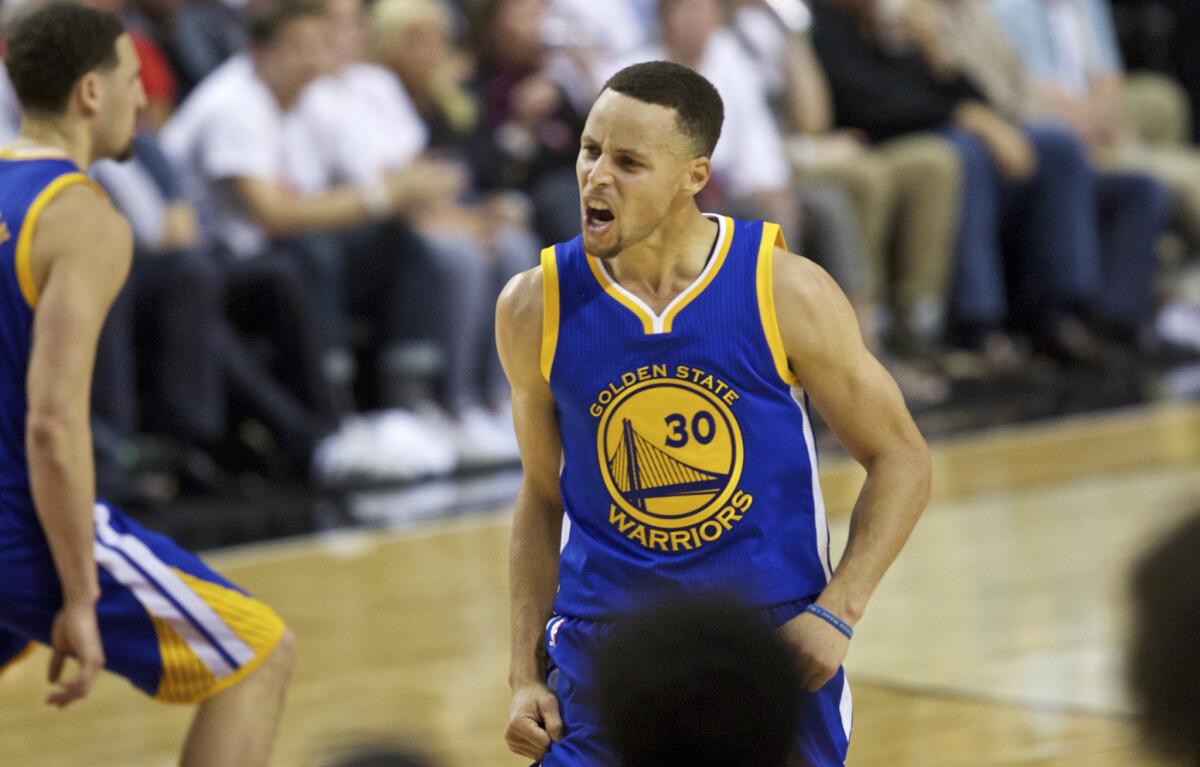 Warriors guard Stephen Curry reacts after making a basket against the Trail Blazers during the second half of Game 4.