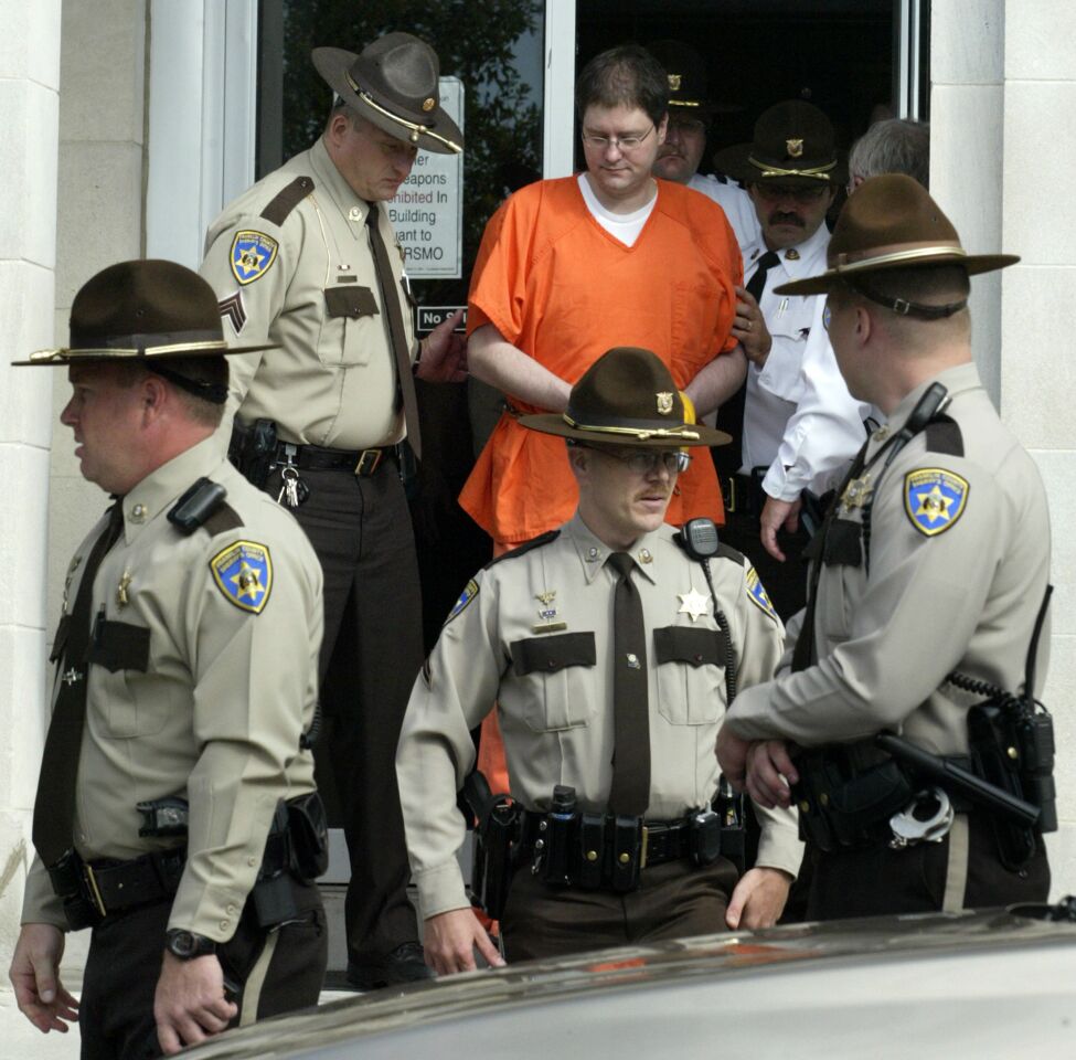 Michael Devlin is escorted out of the Franklin County Courthouse in Union, Mo. Devlin pleaded guilty in Franklin County to one charge of child kidnapping and one count of armed criminal action in the 2007 abduction of 13-year-old William "Ben" Ownby.