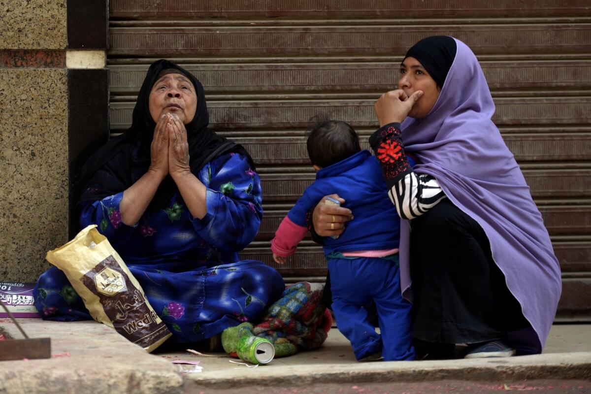 Relatives of supporters of Egyptian ousted Islamist President Mohamed Morsi gather Tuesday outside the courthouse in the central Egyptian city of Minya, during a session of the trial of hundreds of Islamists charged with deadly rioting in an Egypt city.