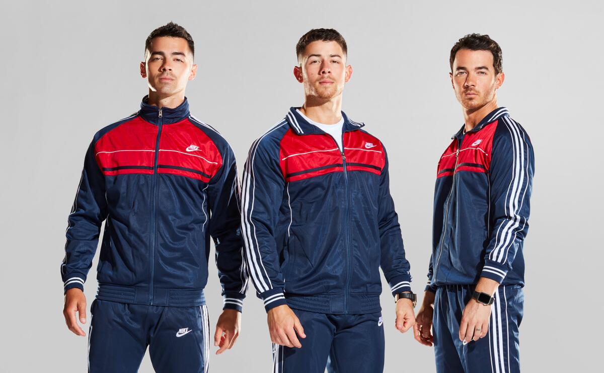 Joe Jonas, Nick Jonas and Kevin Jonas sport matching track suits