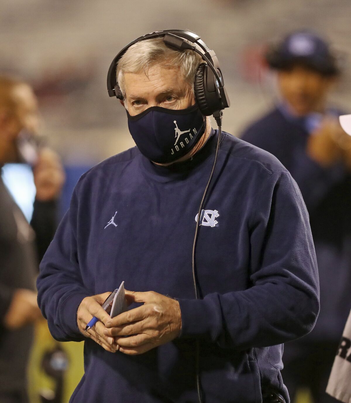 FILE - In this Oct. 31, 2020, file photo, North Carolina coach Mack Brown watches a play during the team's NCAA college football game against Virginia, in Charlottesville, Va. The ACC hosted a Mental Health and Wellness Summit in 2019 in Durham, North Carolina. A second one was planned for last May before being scuttled by the pandemic. “Many years ago, we didn't say much about it (mental health) at all,” North Carolina coach Mack Brown said. Now, it's a frequent topic. (Andrew Shurtleff/The Daily Progress via AP, File)