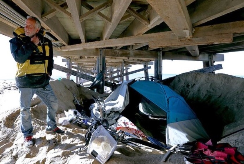 Tom Gallenkamp was camping under the Balboa Pier in Newport Beach on Feb. 6. He said he had been homeless for about eight months after losing his home of about a dozen years when the owner decided to renovate the complex.