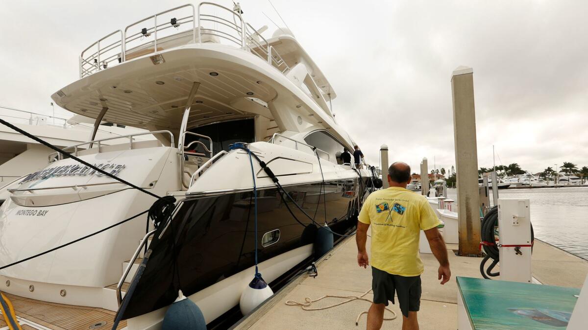 At the Naples Boat Club, million-dollar boats are at risk of being hit by Hurricane Irma. Bill Charbonneau watches over his yachts while the captain ties them down.