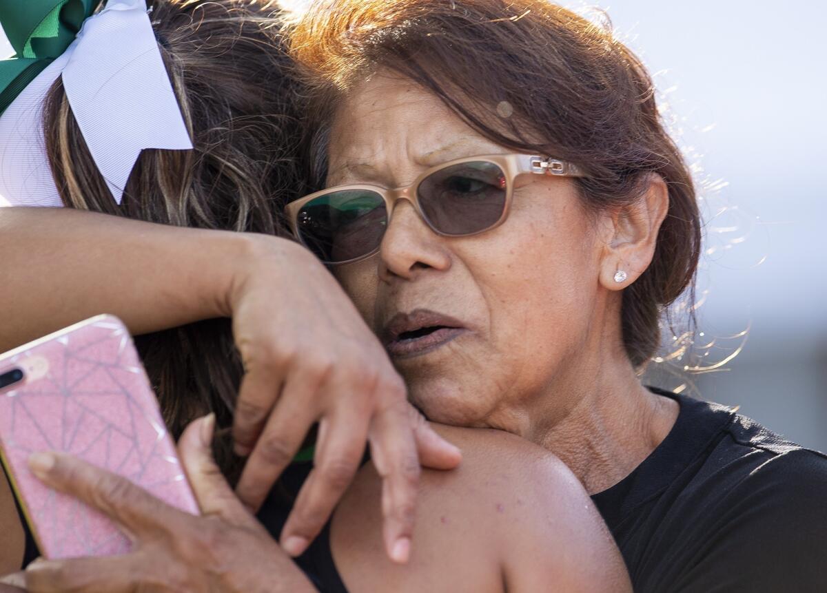 Costa Mesa's Diane Molina gets a hug from her grandmother, Lupe, after finishing first in the Orange Coast League finals at Irvine Regional Park in Orange on Oct. 29, 2018.